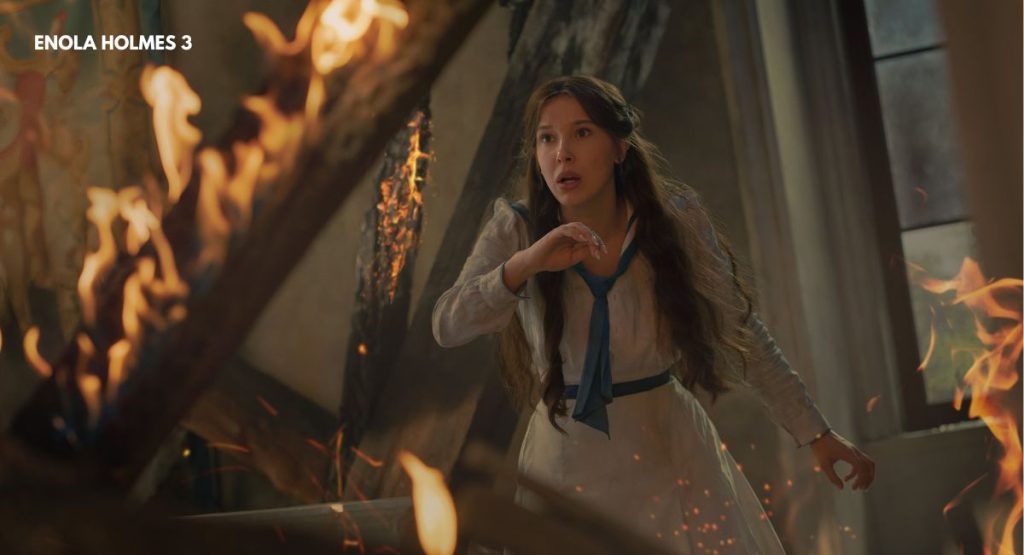  Enola Holmes 3 release date first look Millie Bobby Brown action scene surrounded by fire