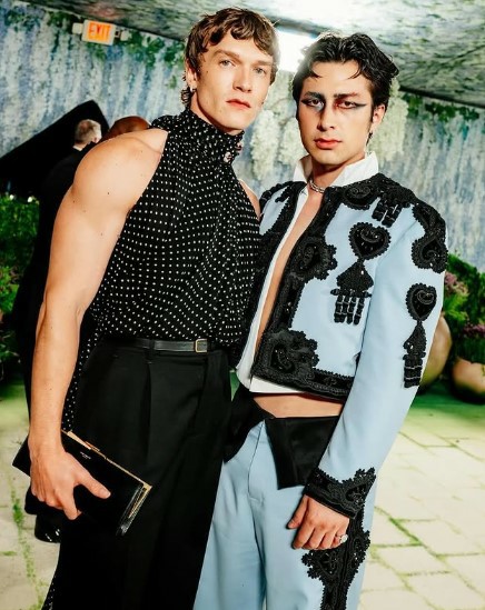 Hudson Williams standing next to Connor Storrie at the 2026 Oscars after-party, showing comparable heights